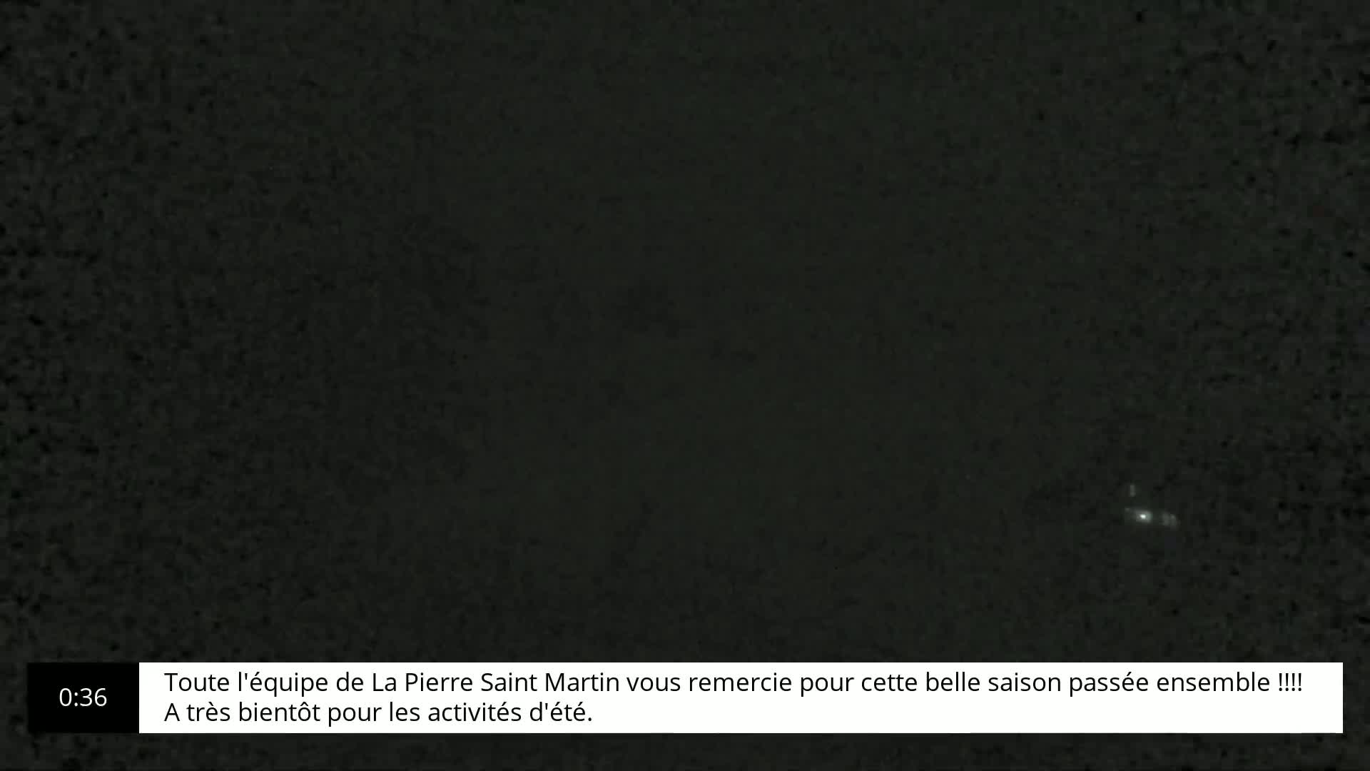 A dark, nighttime scene shows a few faint, distant lights in the sky.