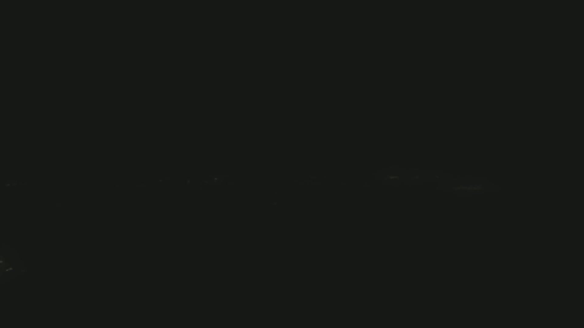 A very dark image shows a faint, horizontal line of light possibly indicating a distant city skyline at night.