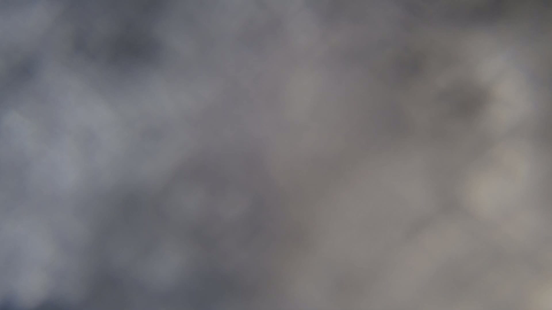 A blurry image shows a mostly gray and overcast sky.