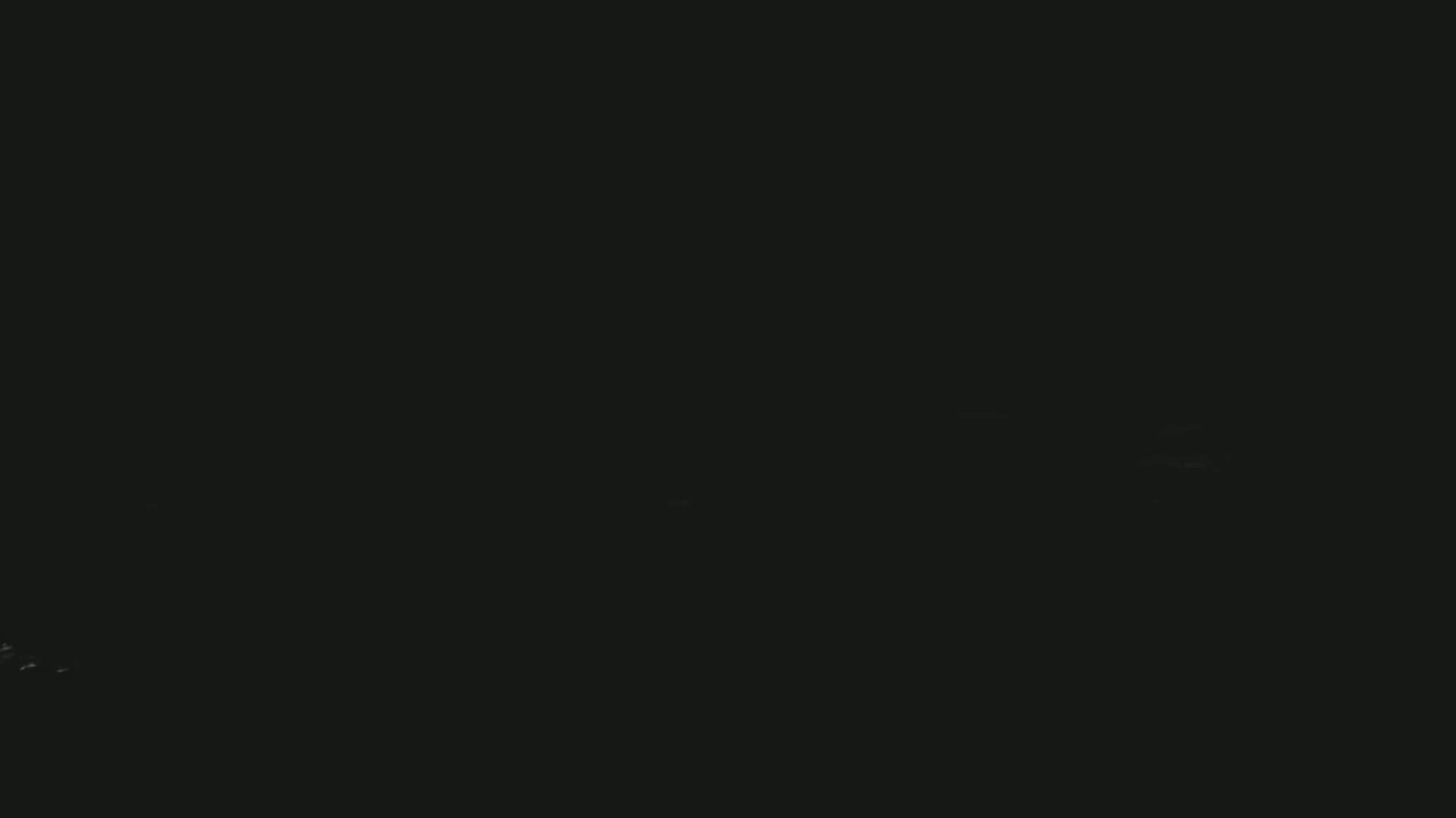 The image is almost entirely black, with a few faint, barely visible specks of light.