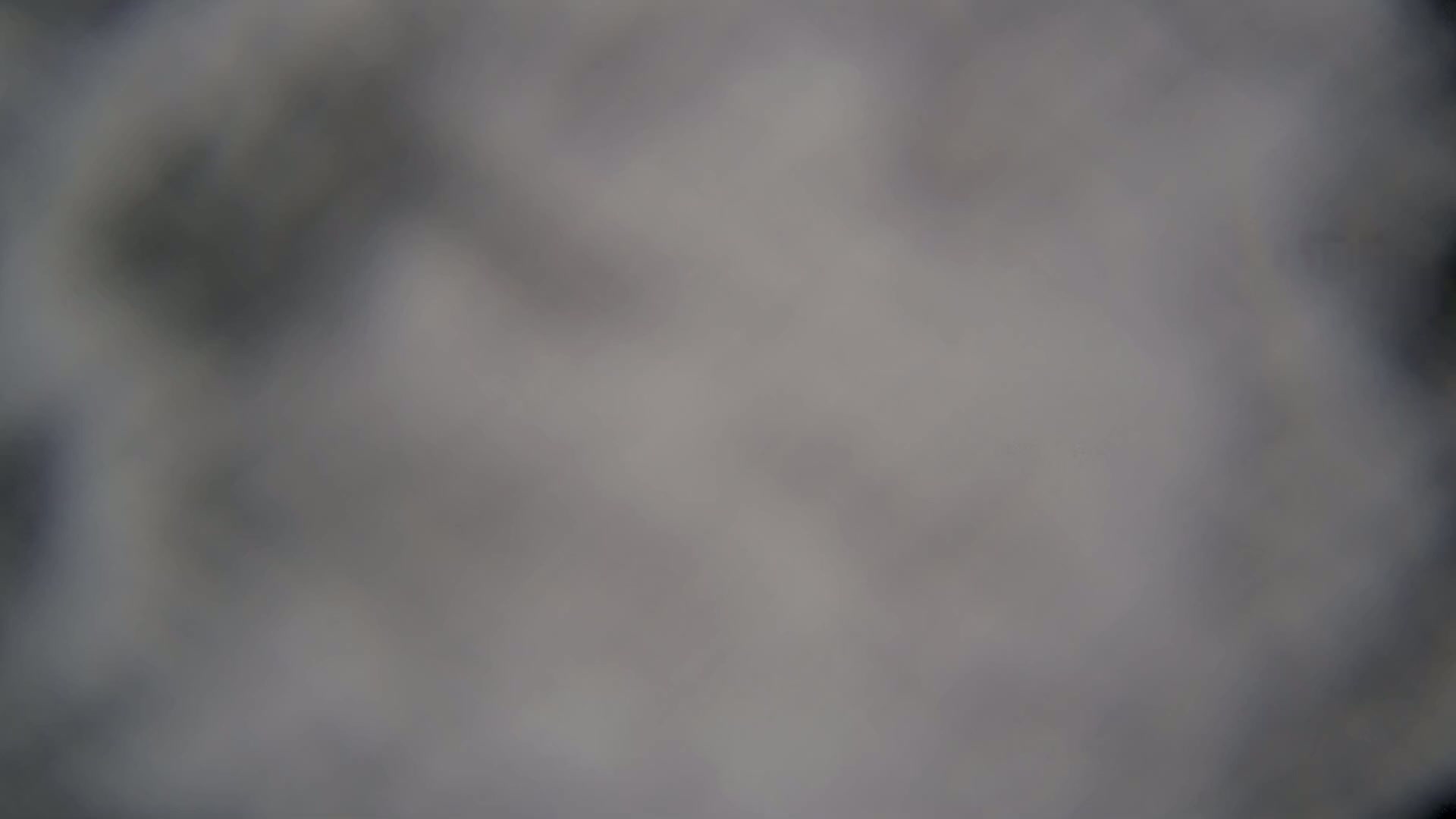 A blurry, out-of-focus image shows a mostly gray and white scene.