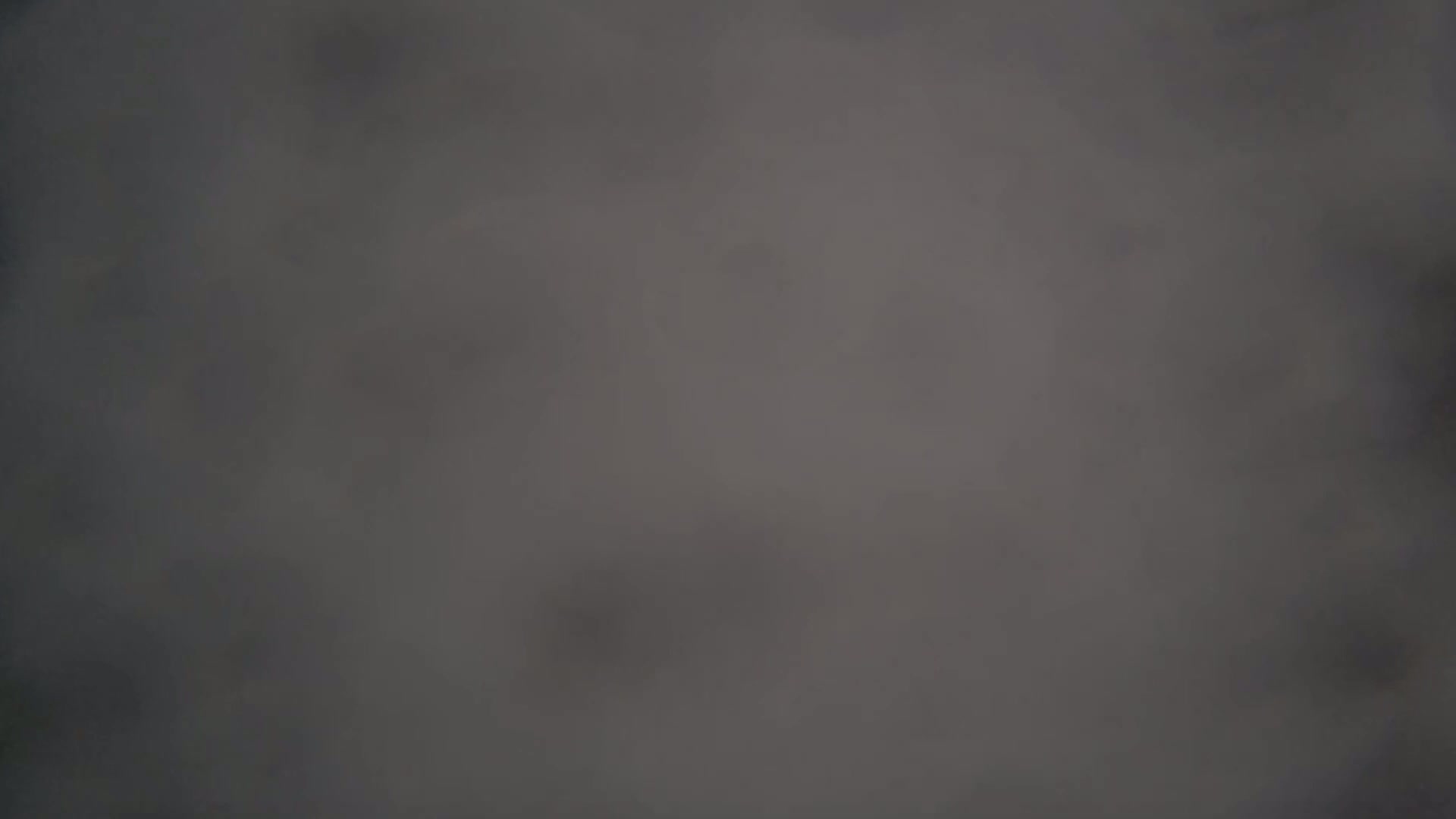 A blurry, dark gray image shows an indistinct, out-of-focus scene.
