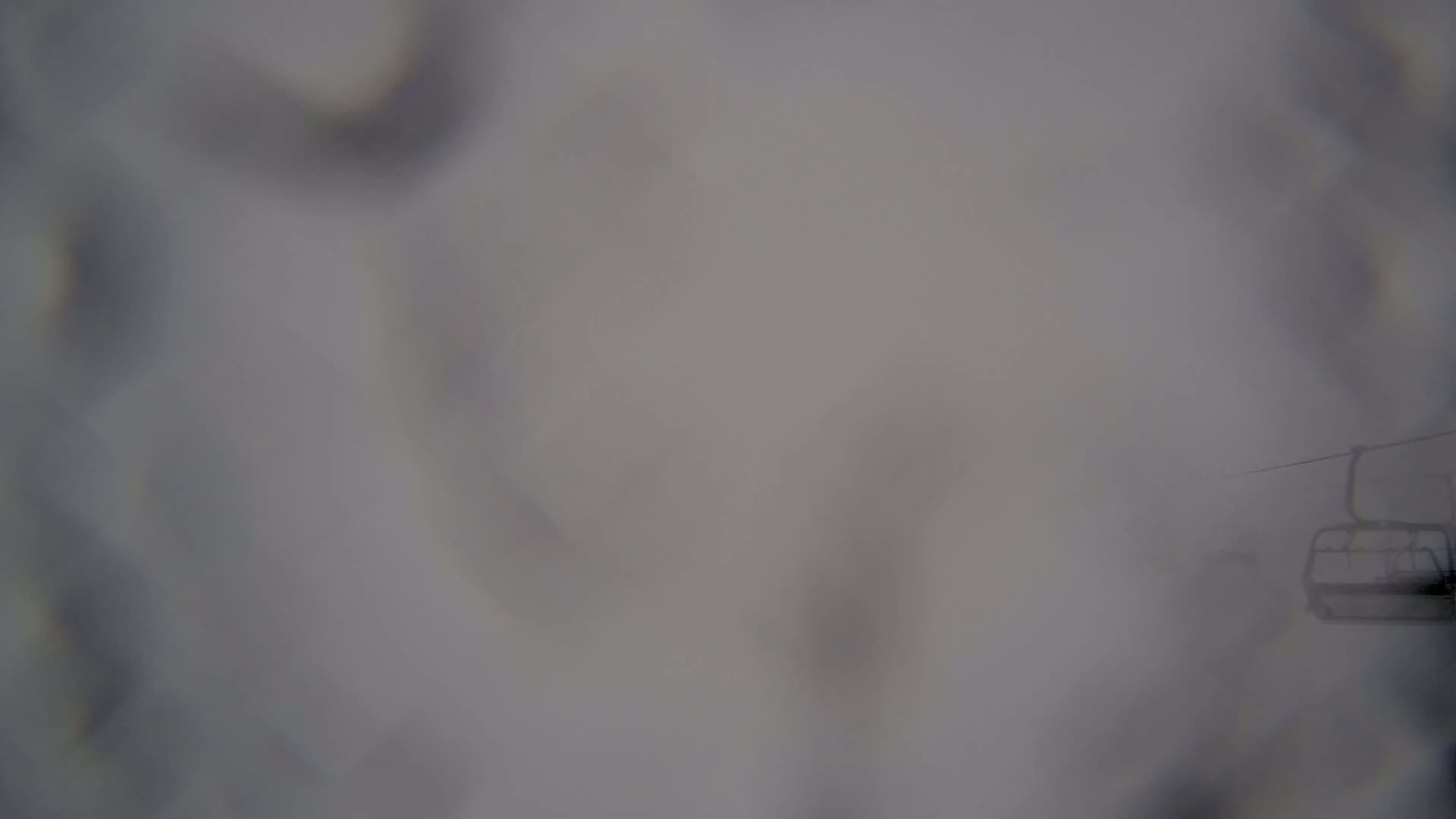 A blurry image shows a chairlift in dense fog.