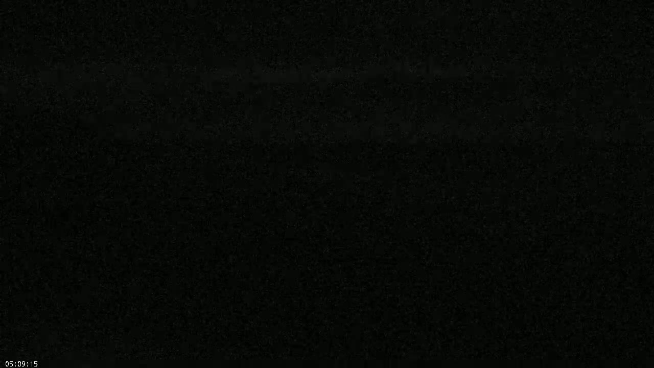 The image shows a completely dark, grainy scene.