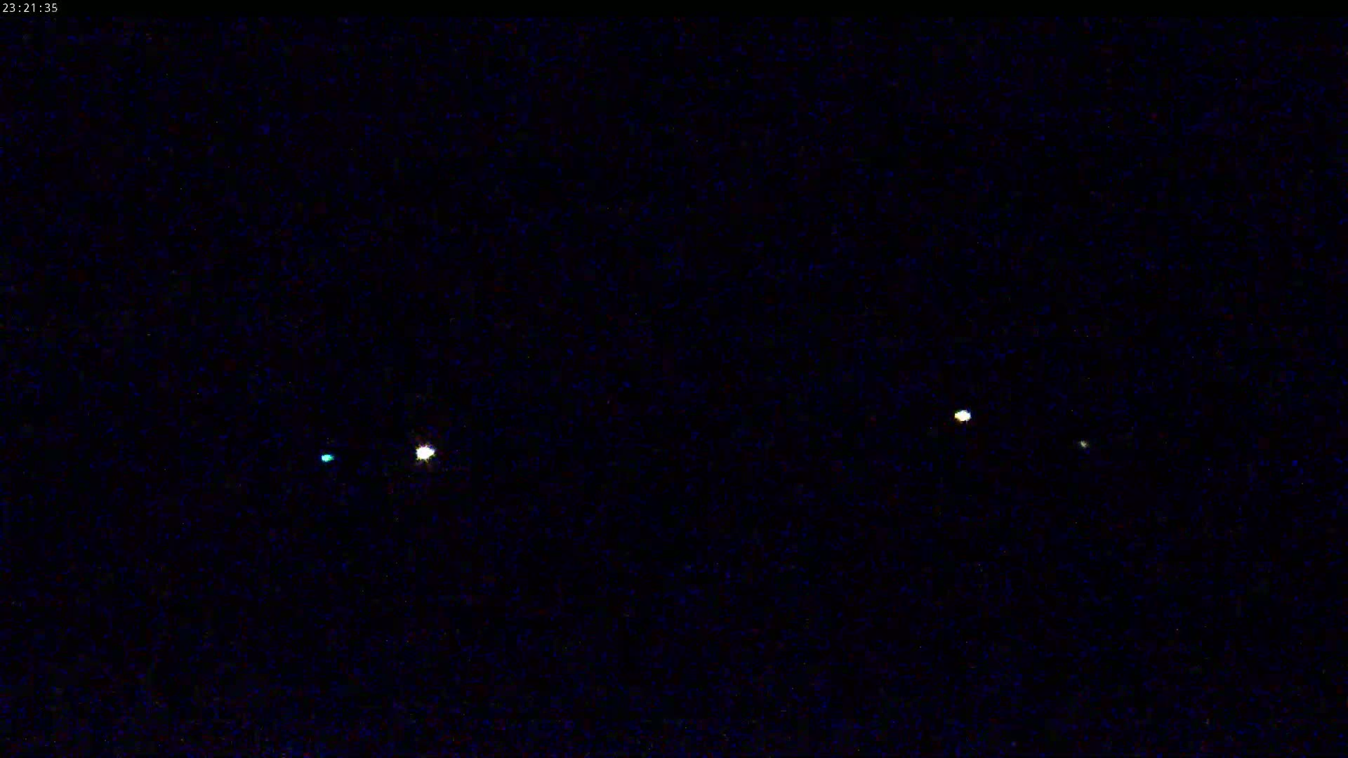 Four lights are visible in the night sky.