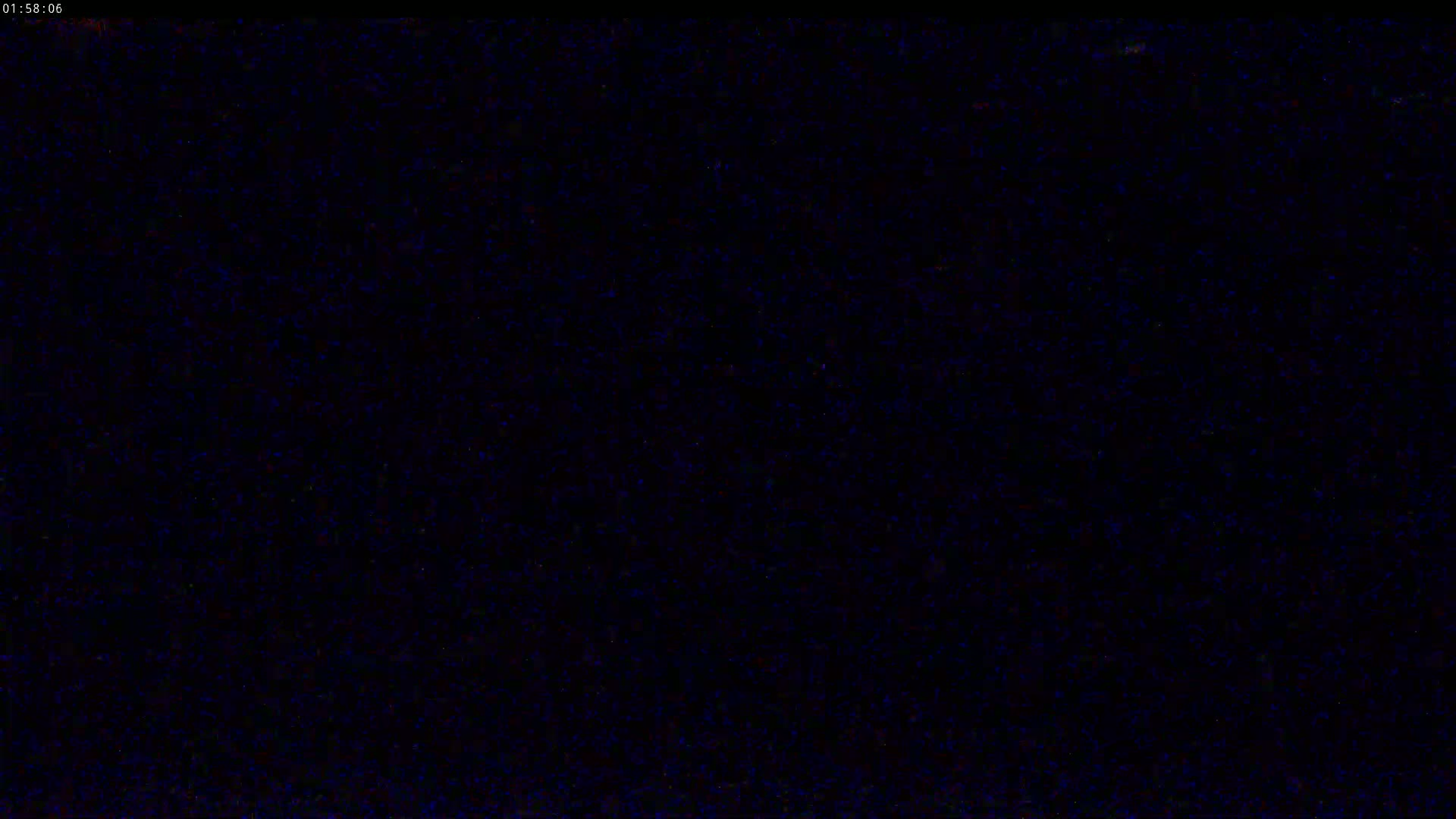 The image shows a completely dark screen with slight blue speckles.