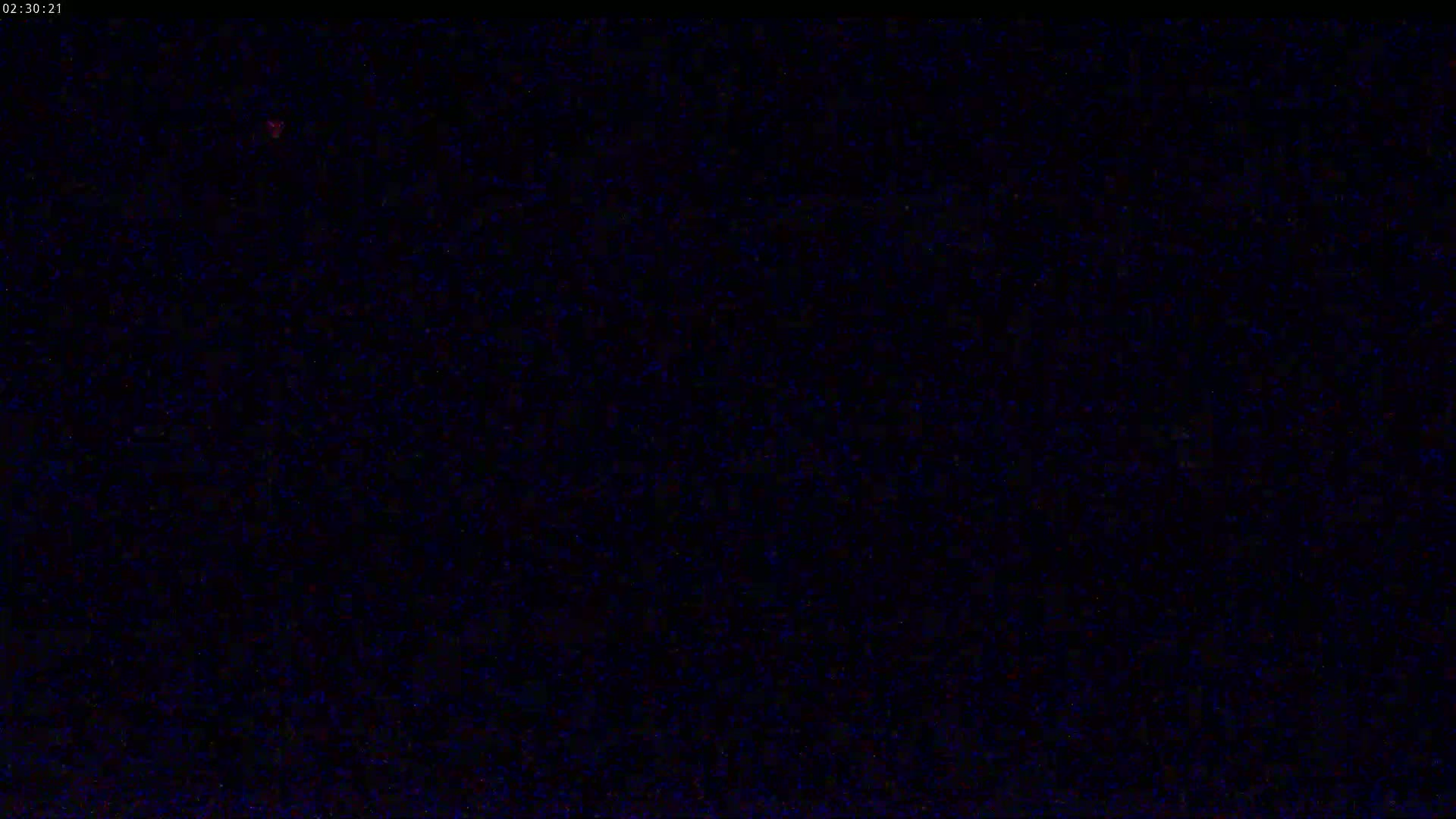 The image shows a completely dark, grainy screen.