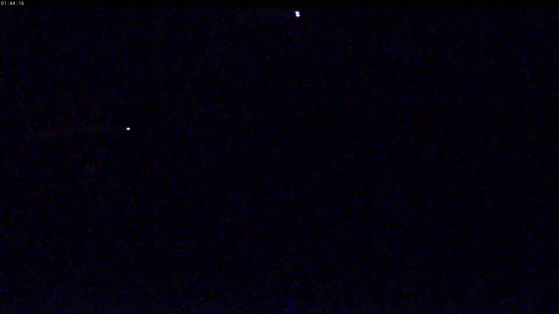 A dark, night sky shows two bright stars.