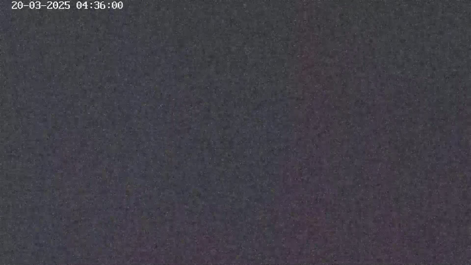 The image shows a dark, grainy, and indistinct surface.
