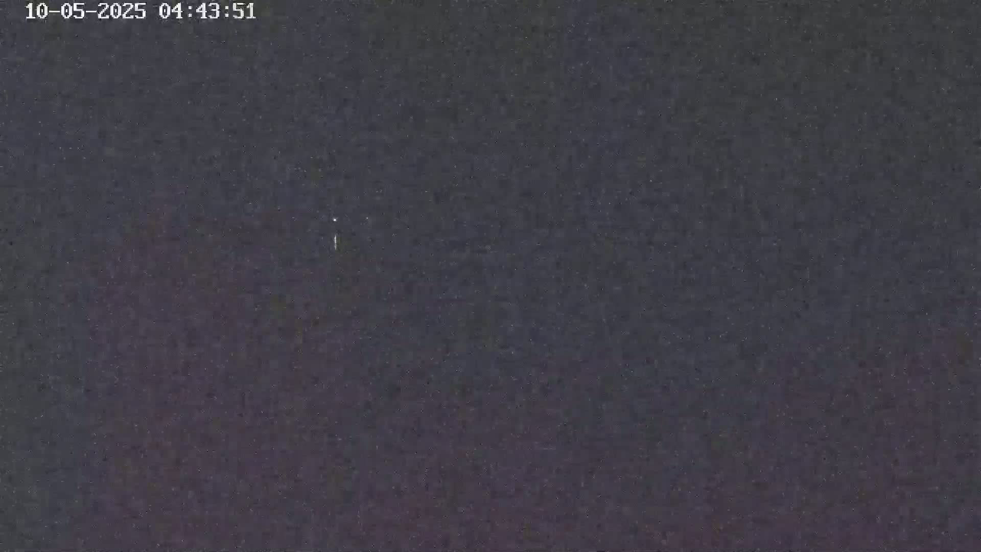 A dark, nighttime sky shows a few faint stars.