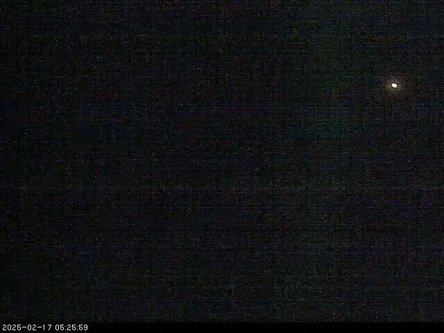 A dark nighttime sky shows a single bright light, possibly a star or planet.