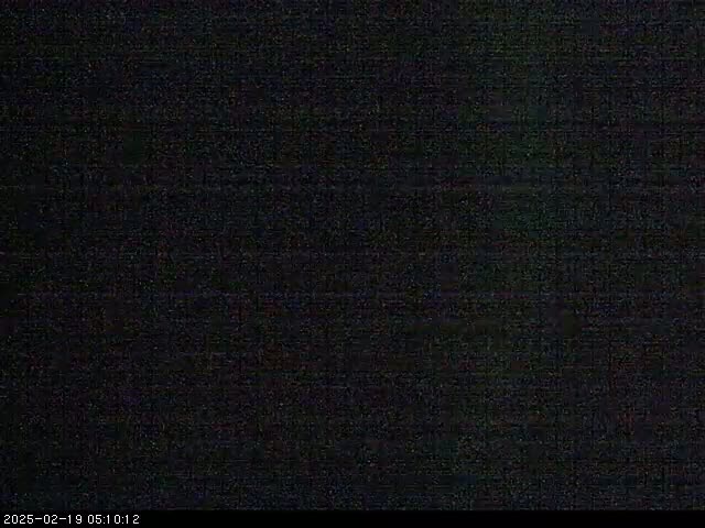 The image shows a completely dark screen with subtle grain.