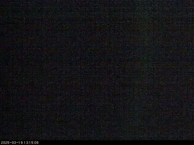 The image shows a completely dark screen with only slight speckling of lighter pixels visible.