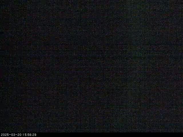 The image shows a completely dark, grainy screen.