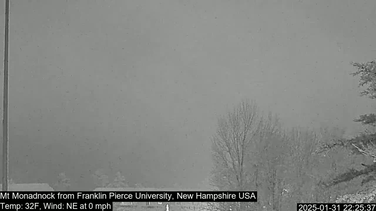 A snow-covered landscape is visible under a gray sky with calm winds.