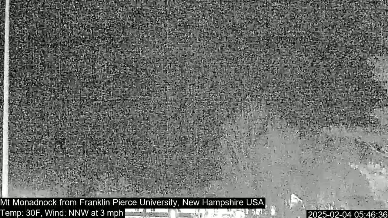 A distant, snow-covered landscape is visible through a hazy, possibly snowy atmosphere.