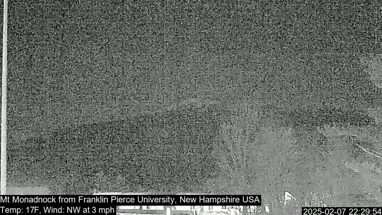 A nighttime, low-light view of a snow-covered landscape with a northwest wind at three miles per hour and a temperature of seventeen degrees Fahrenheit.