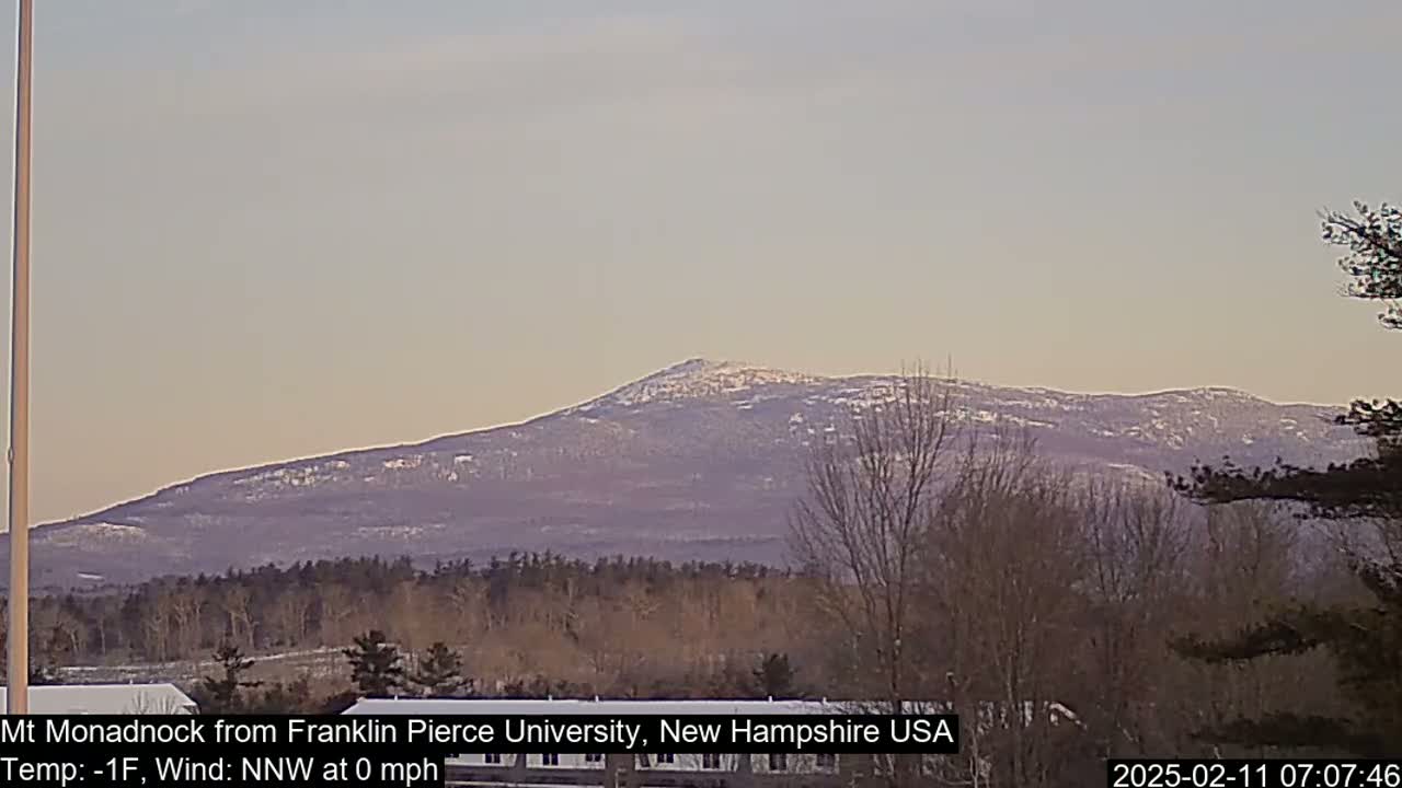 A snow-dusted mountain range is visible in the distance under a pale, clear sky.