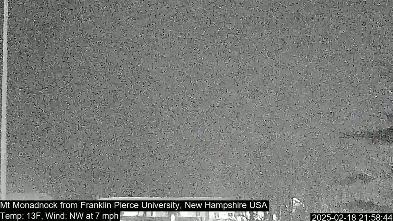 A grainy, nighttime image shows a dark, overcast sky with a northwest wind at seven miles per hour and a temperature of thirteen degrees Fahrenheit.