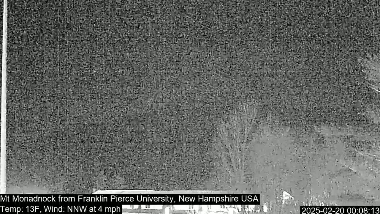 A nighttime, low-resolution view of a snow-covered landscape with a north-northwest wind at four miles per hour and a temperature of thirteen degrees Fahrenheit.
