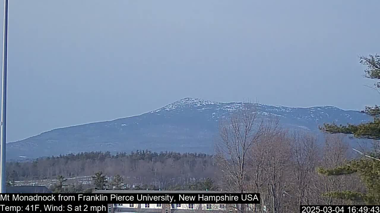 A snow-dusted mountain is visible in the distance on a clear, cool day.