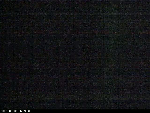 The image shows a completely dark, grainy screen.