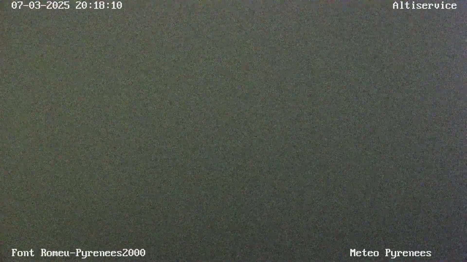The image shows a uniformly dark gray, possibly nighttime, outdoor scene.