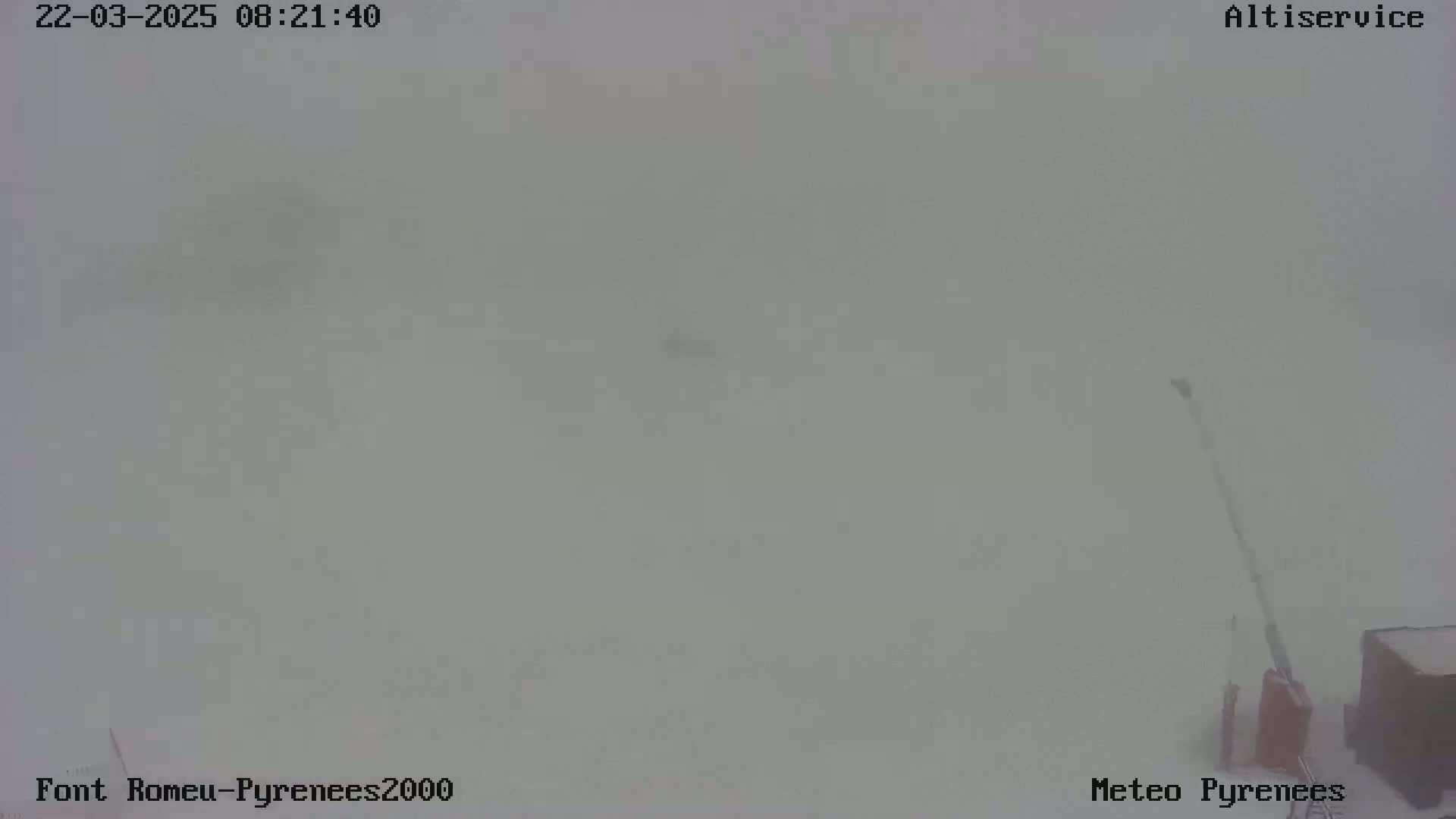 A mostly obscured outdoor scene shows heavy snow obscuring visibility.