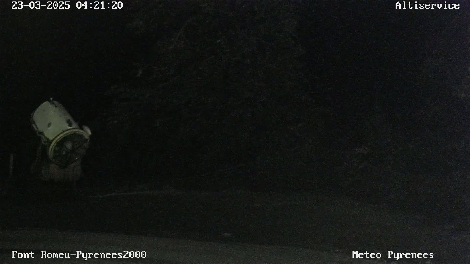 A cylindrical object is visible in the dark, possibly nighttime, outdoors.