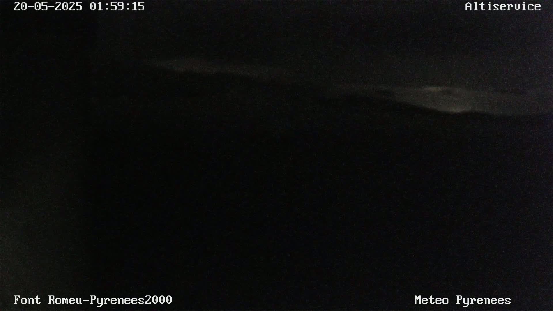 A dark, nighttime scene shows a faintly illuminated horizon line.