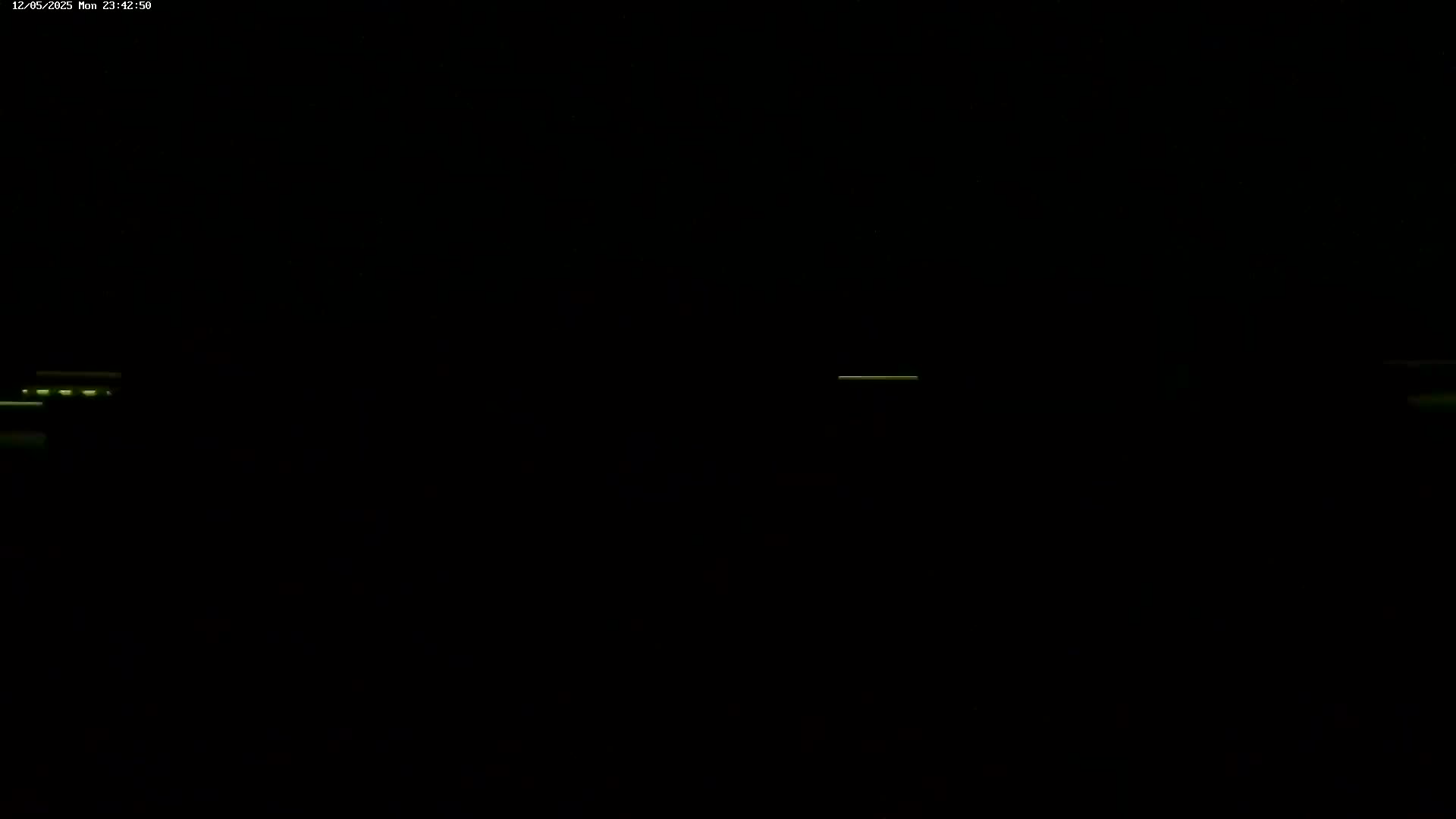 The image shows a mostly black screen with faint, horizontal lines of pale green light.