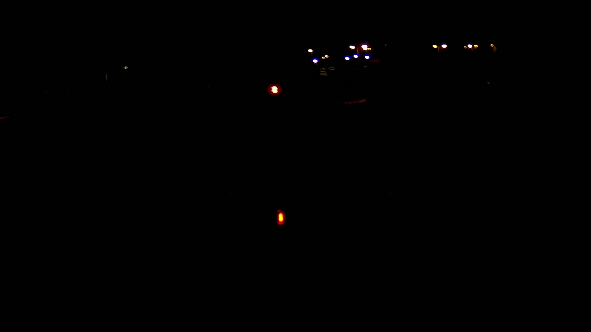 Distant lights are visible in the darkness of night.
