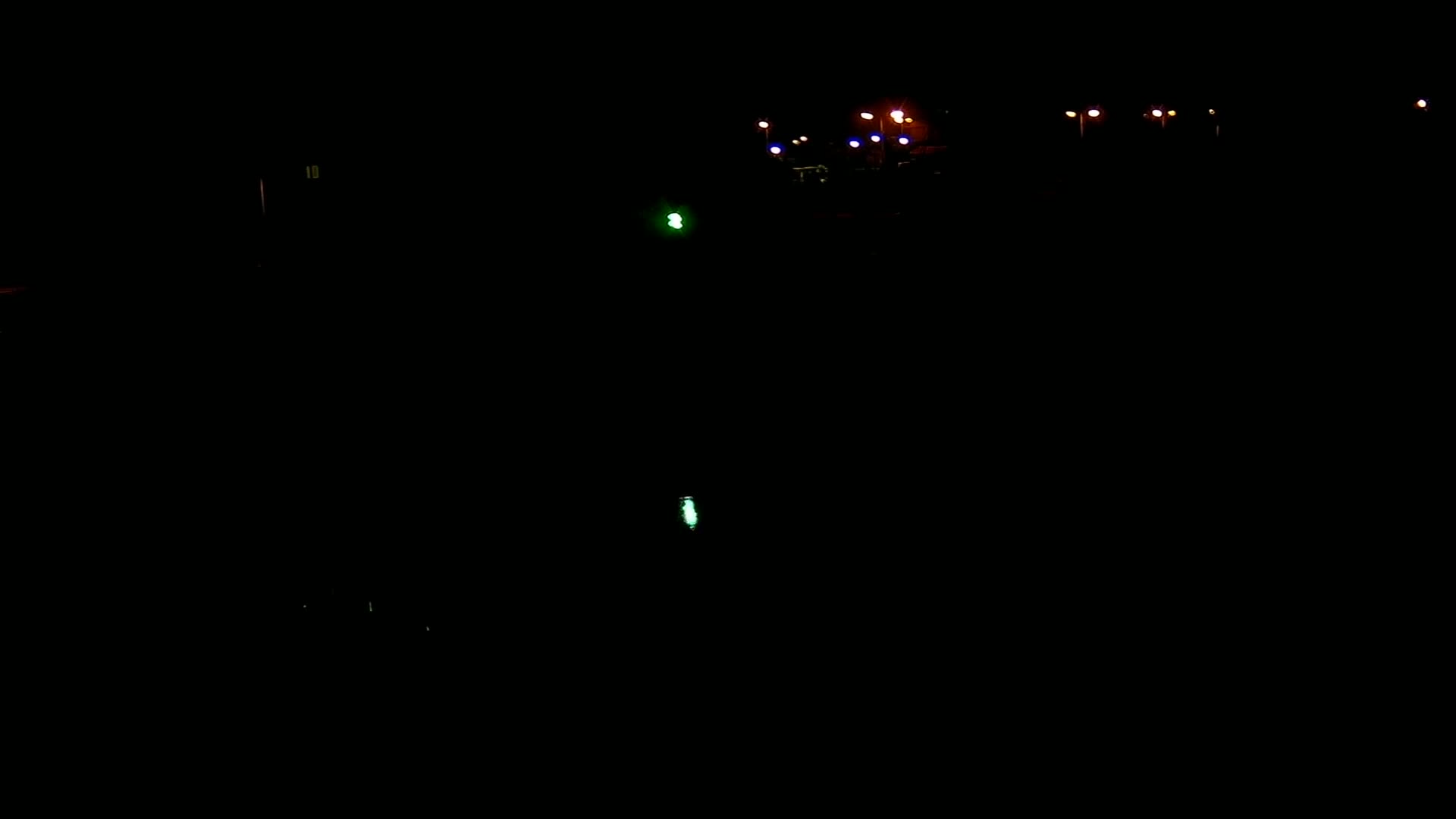 Distant lights illuminate a dark, nighttime scene.