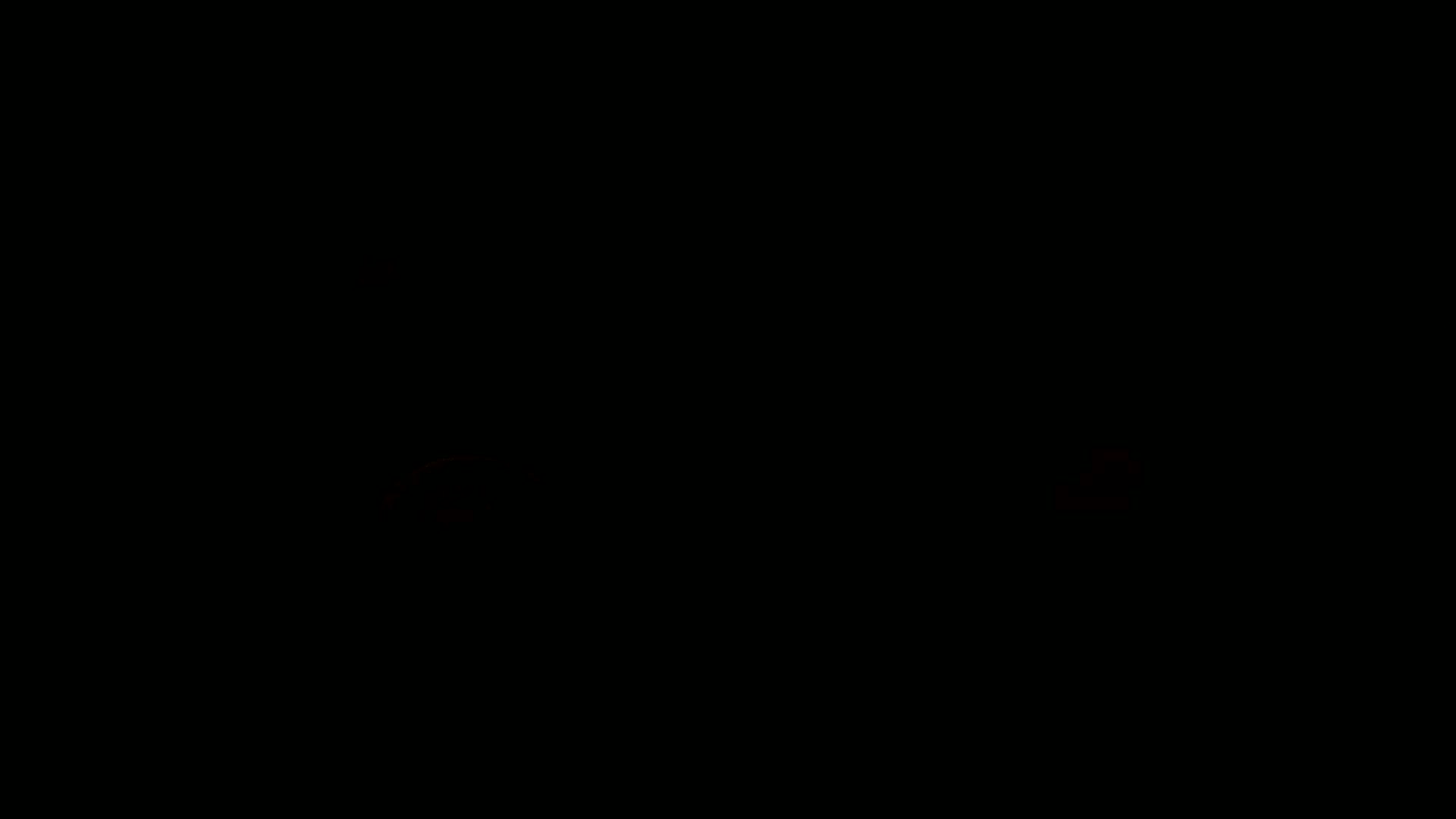 The image is almost entirely black, with faint, blurry reddish-orange lights visible near the bottom edges.