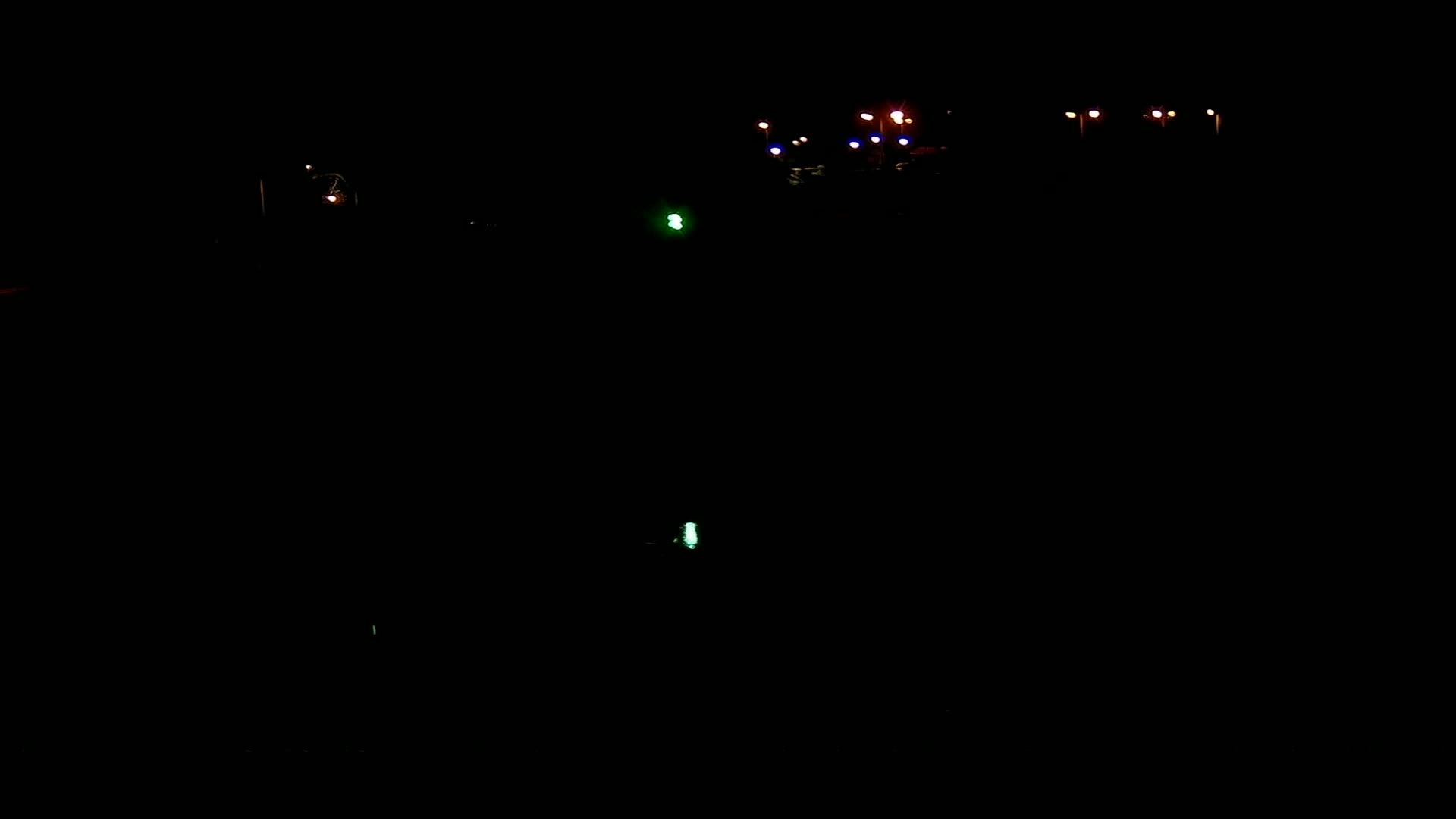 Faintly lit streetlights and other lights are visible in the dark of night.