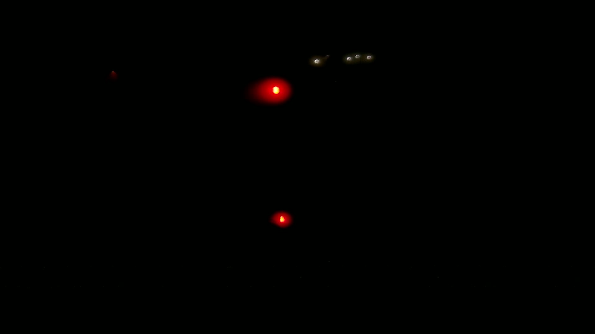 Several red and white lights are visible in the darkness.