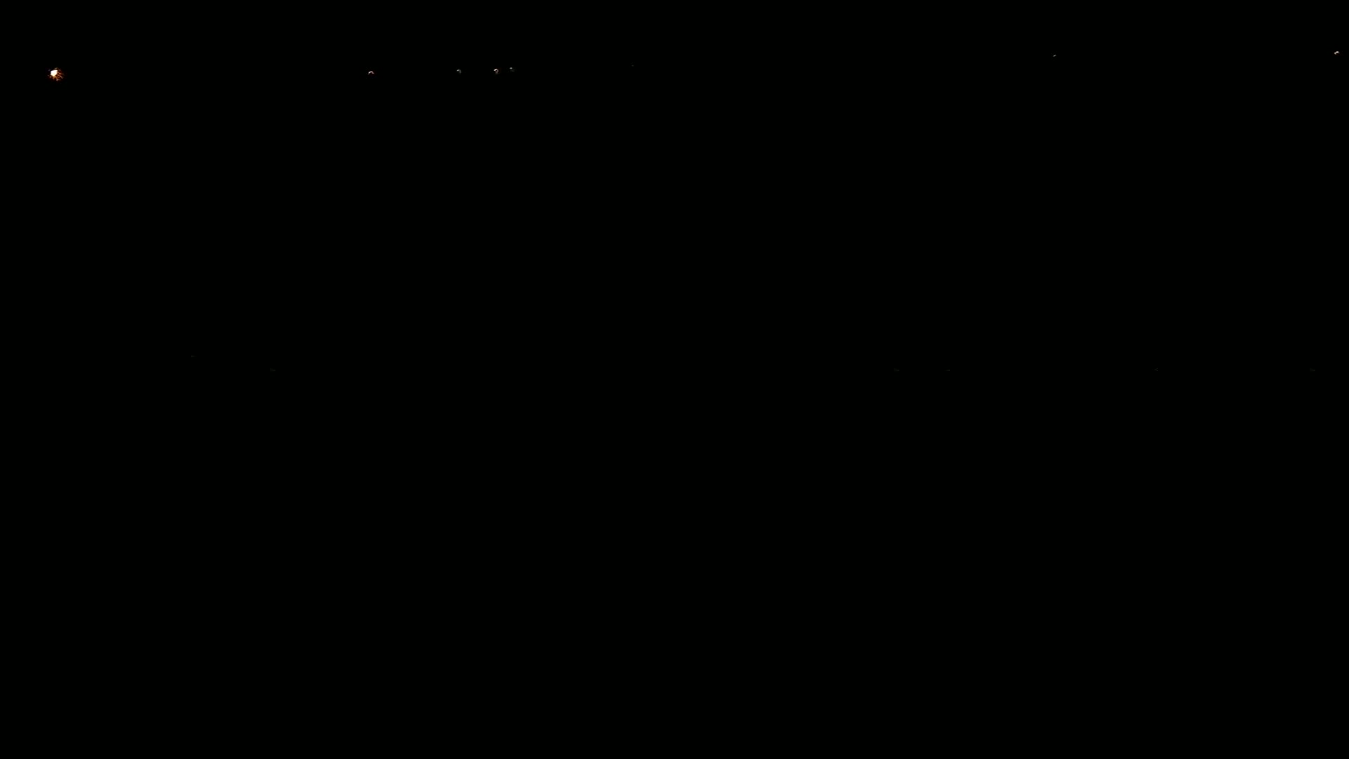 A mostly black image shows several small, faint orange lights scattered across the top.