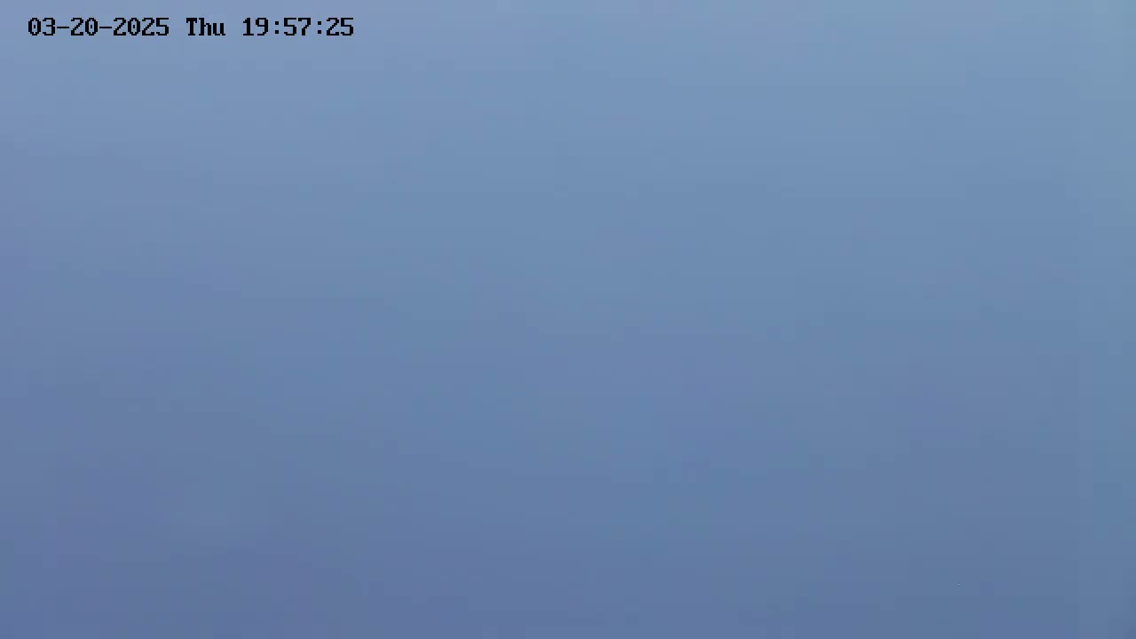 The image shows a solid, light-blue sky.