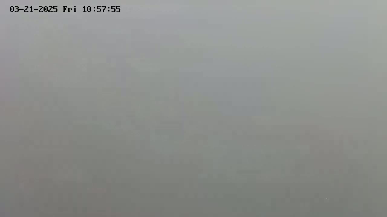 A very foggy or hazy scene obscures any discernible details.