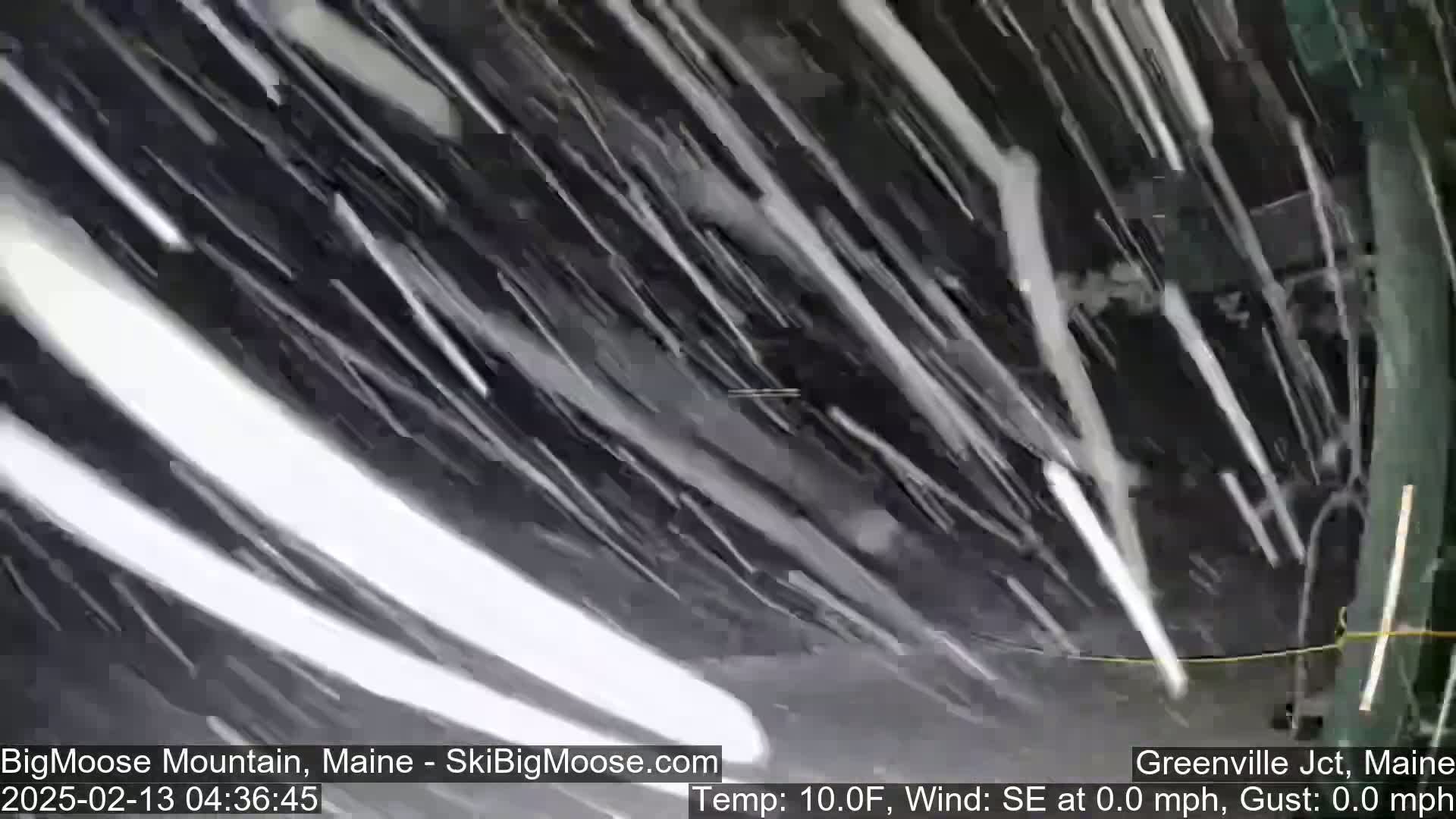 Heavy snow is falling during a calm, ten-degree Fahrenheit wind.