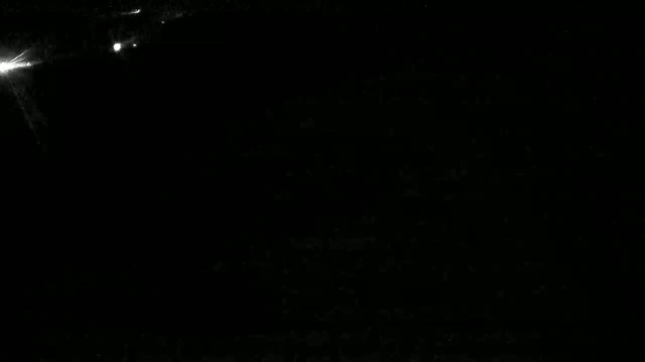 A dark image shows several bright, star-like points of light against a mostly black background.