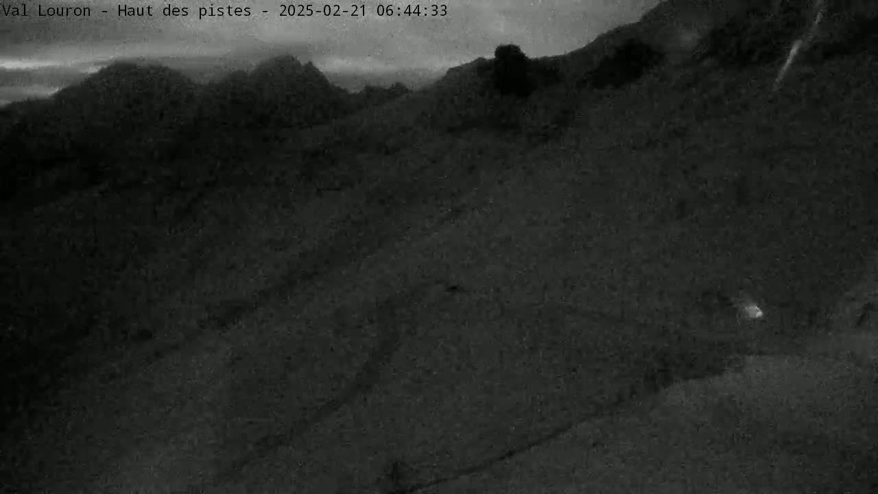 A dark, overcast view of a mountainous landscape at night.