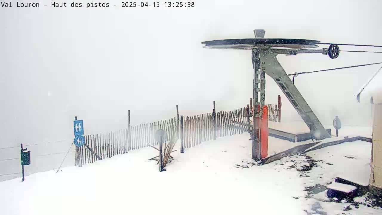 A snow-covered ski lift station is visible in heavy snowfall.