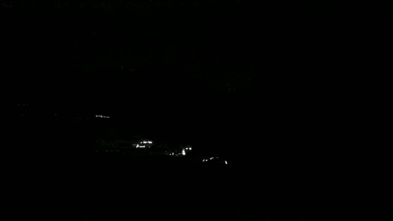Faint lights are visible on a dark, possibly nighttime, body of water.