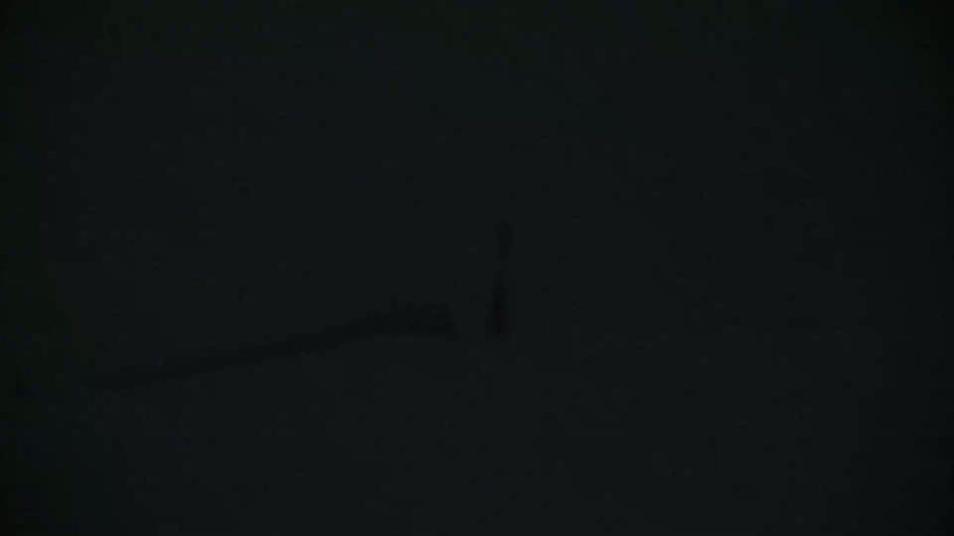 A very dark image shows indistinct shapes suggesting a landscape under extremely low light conditions.