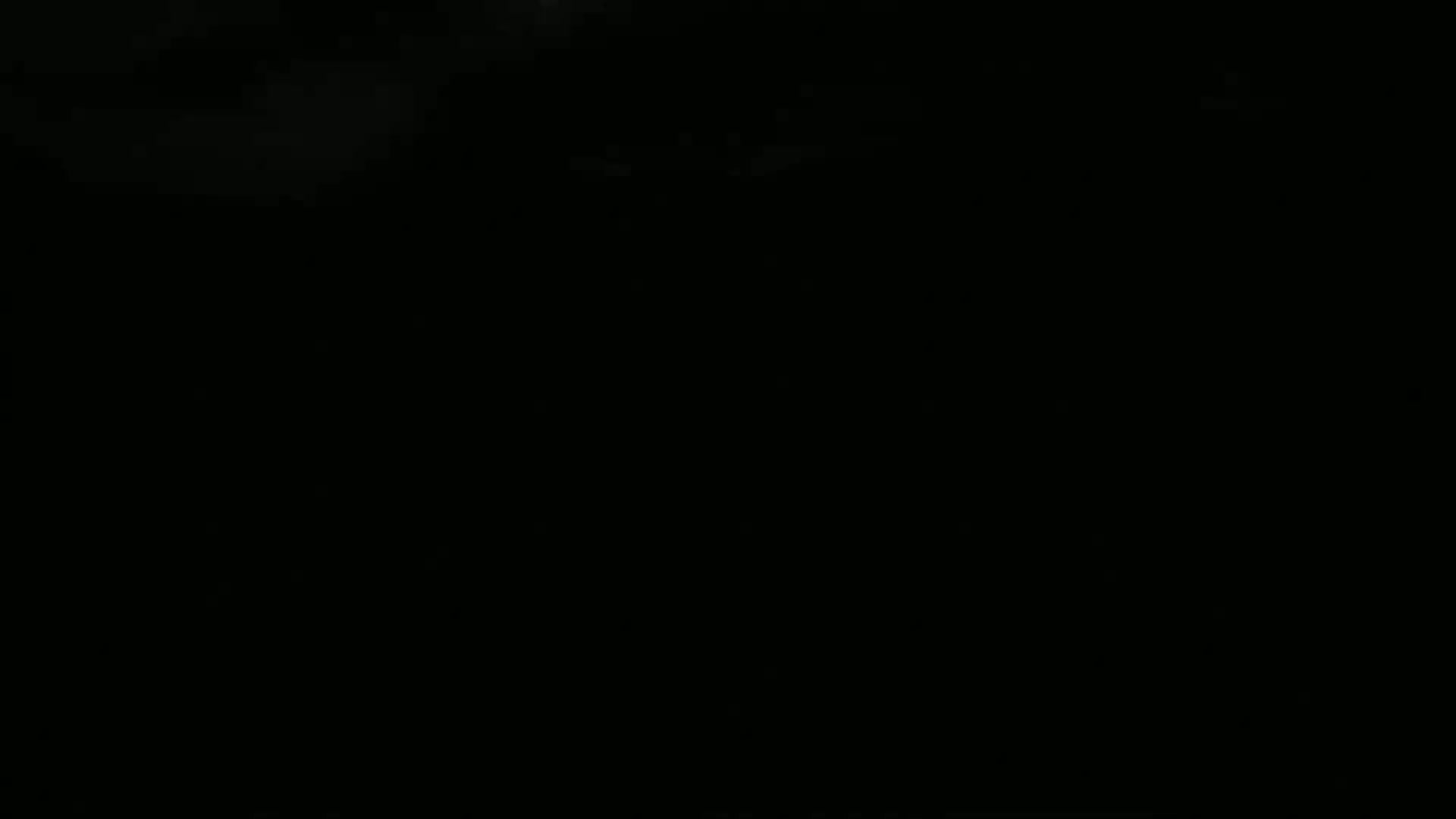 The image is completely black, possibly depicting a nighttime scene with some faint, indistinct light in the upper left corner.
