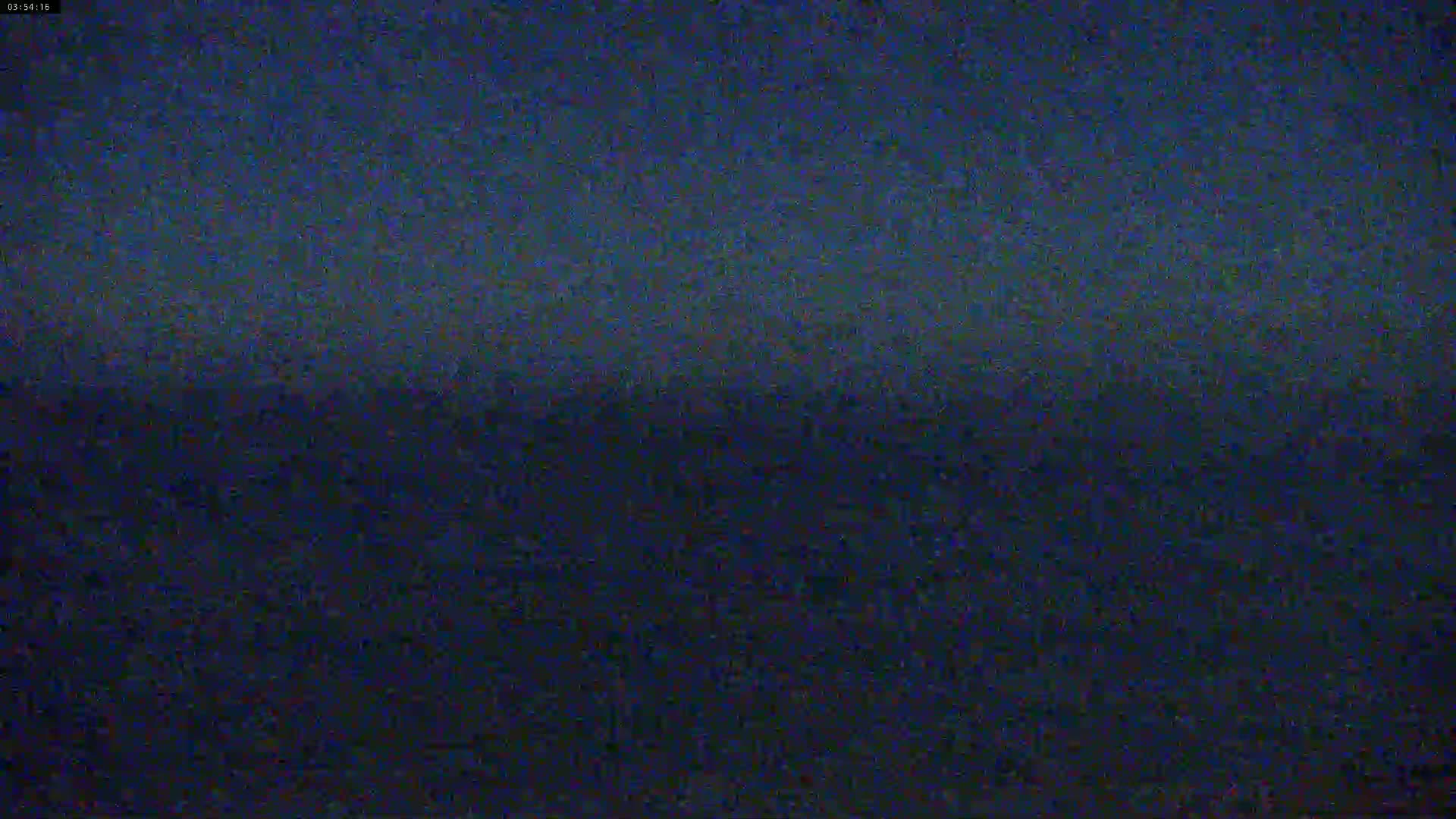 A dark, grainy image shows a dark blue expanse, possibly the ocean at night.