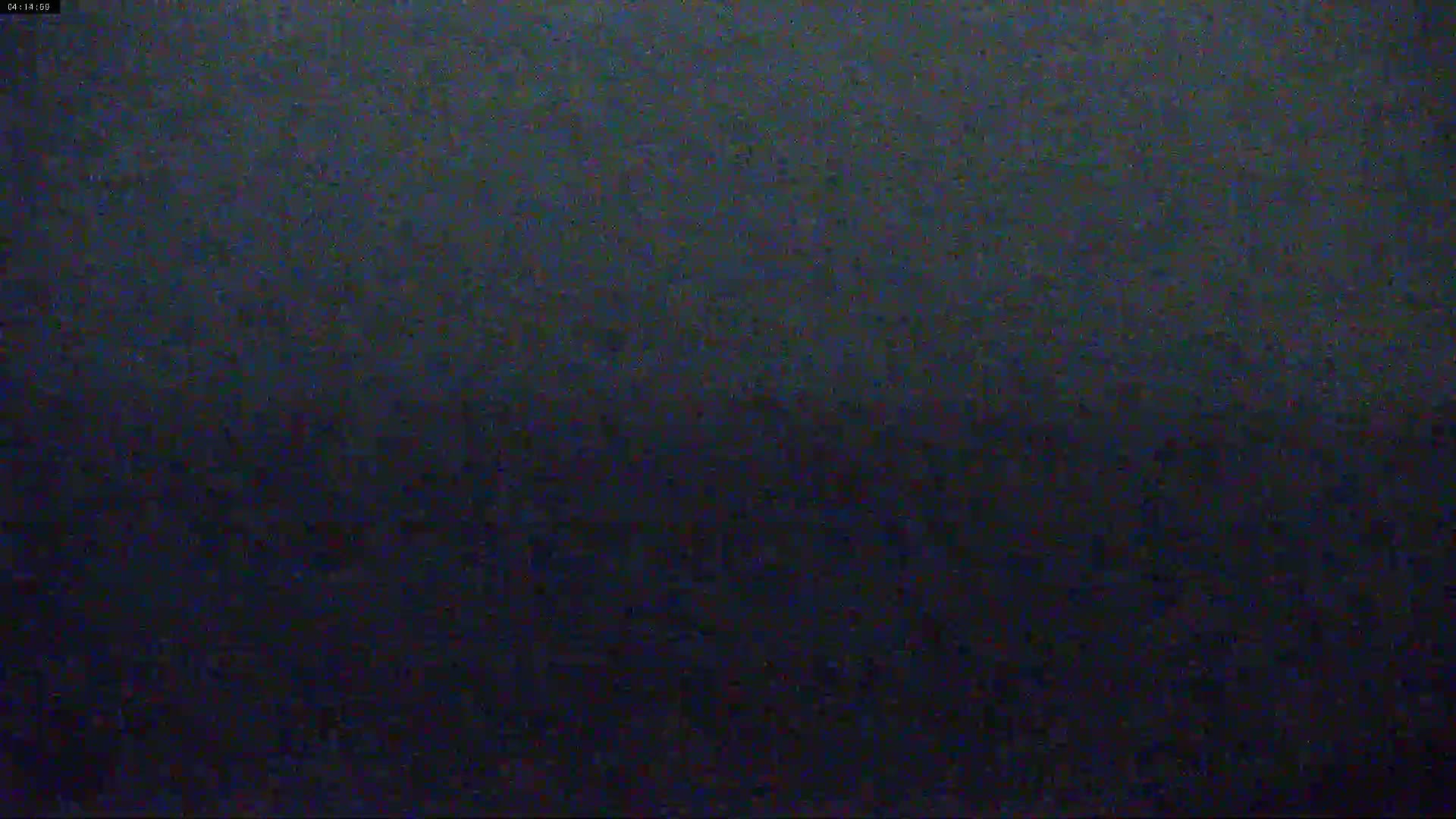 A dark, blurry image shows a mostly featureless expanse of dark blue and black, possibly at night.