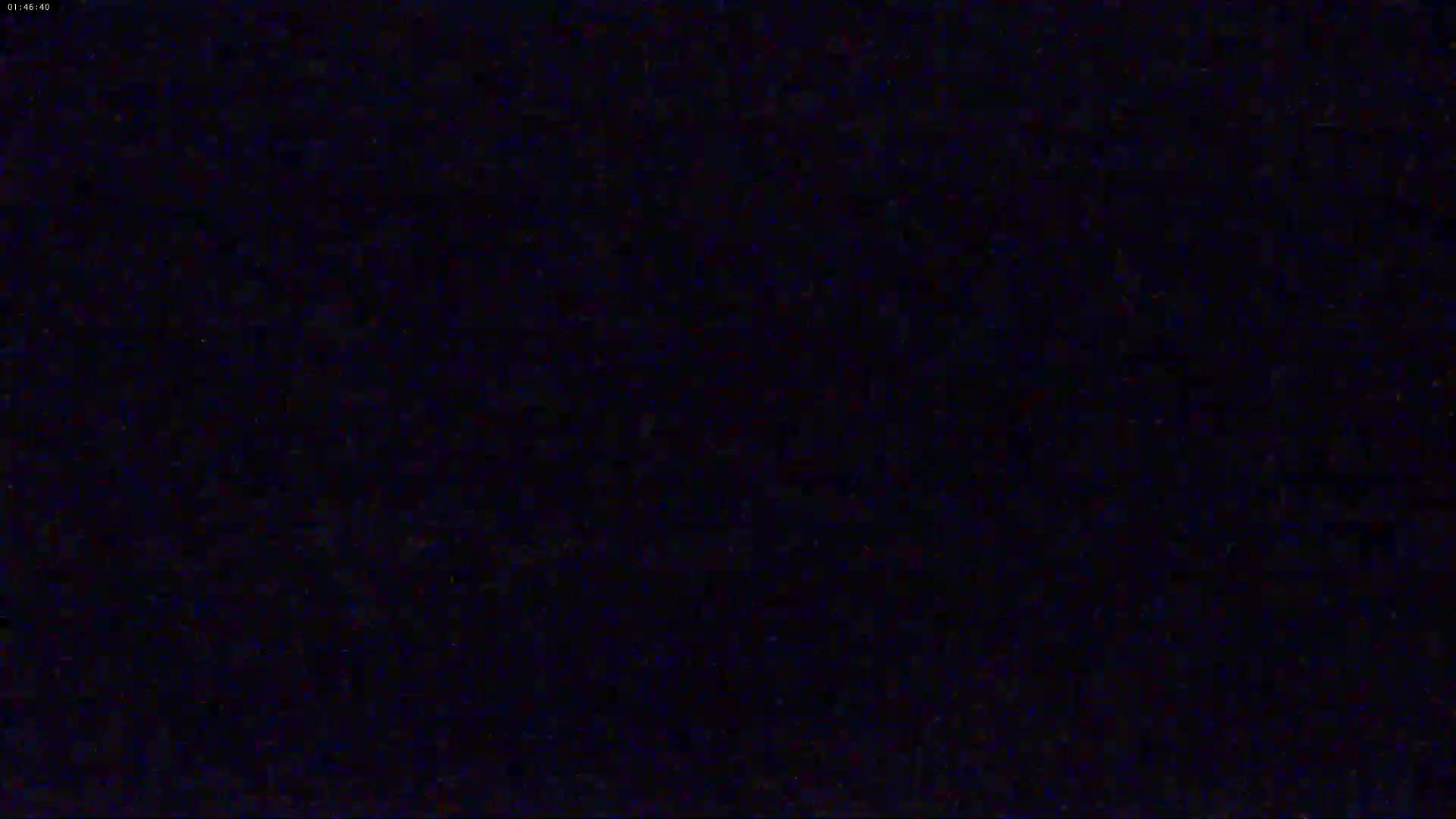 The image shows a completely dark, grainy screen.