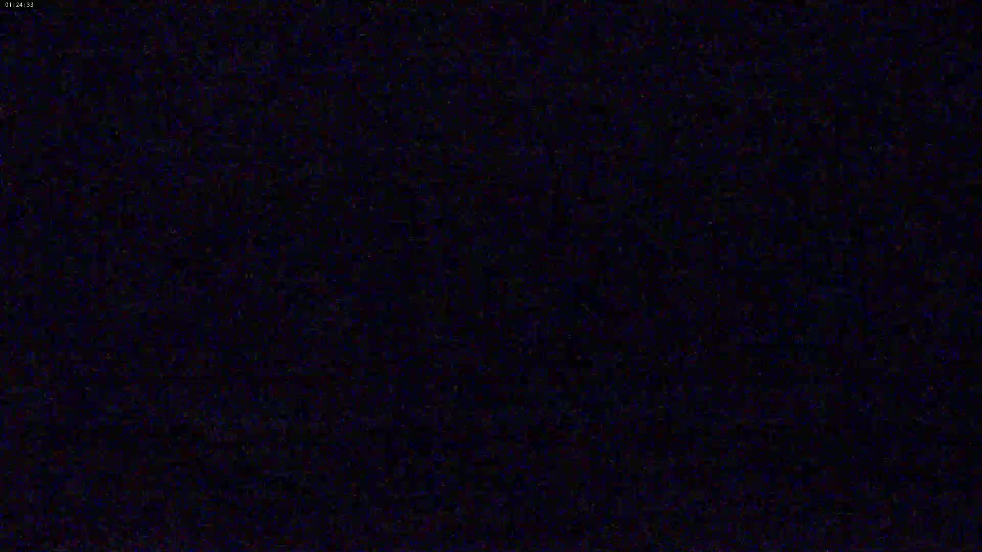The image is a completely dark, grainy, black screen.